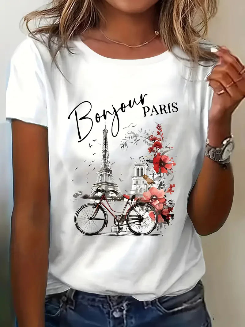 Women’s Paris tee flat lay with sunglasses, jeans, and travel accessories