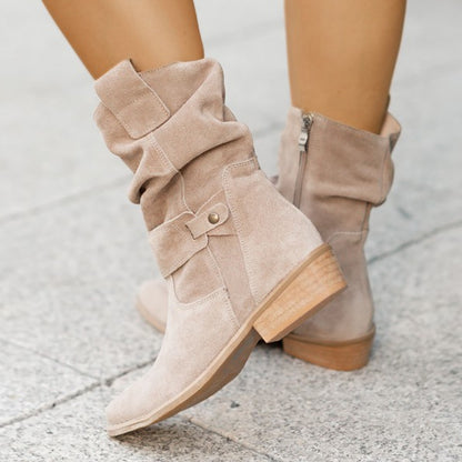Brown suede boot lifestyle shot with autumn leaves

