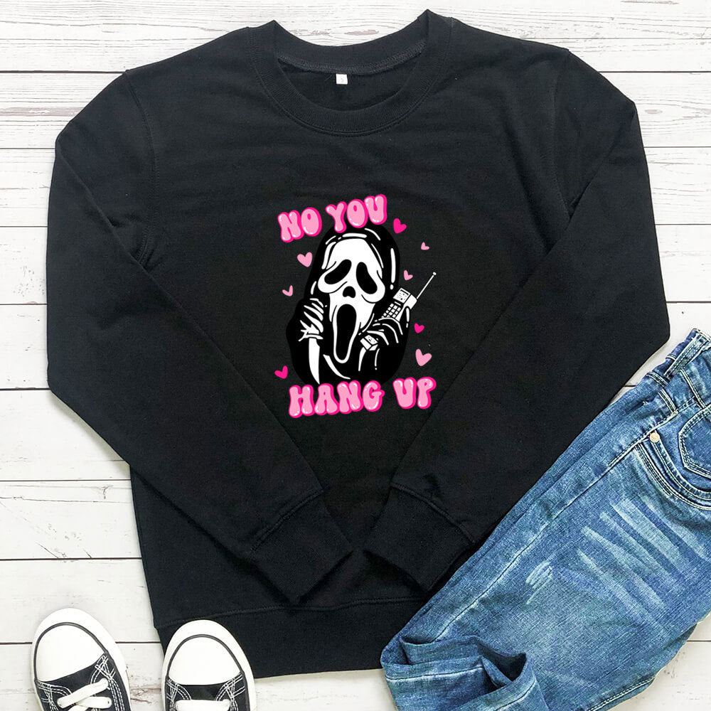 Original image: Black printed crewneck sweatshirt laid flat beside a pair of jeans pictured with the garment details visible.