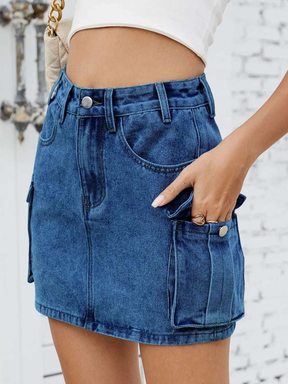 Cargo denim skirt flatlay with sunglasses and phone for styling idea

