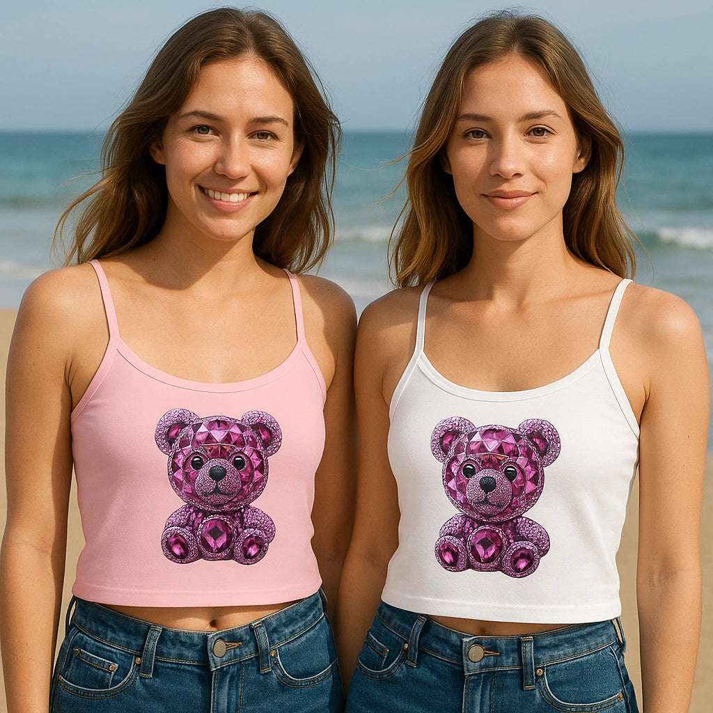 Woman wearing sparkly bear tank top, smiling on a sunny beach.

