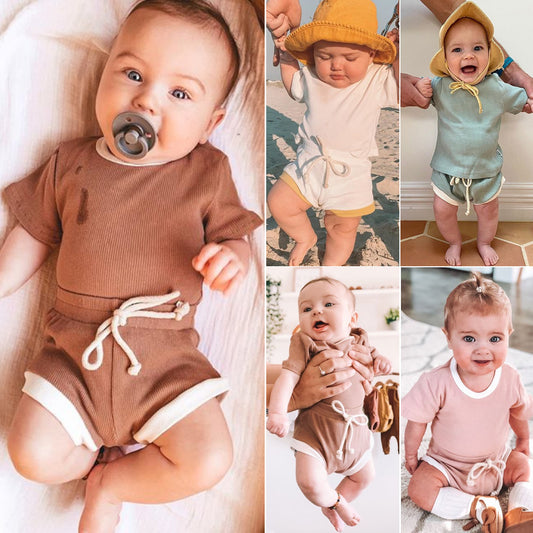 Close-up of non-hooded infant two-piece set featuring diagonal single-breasted closure.