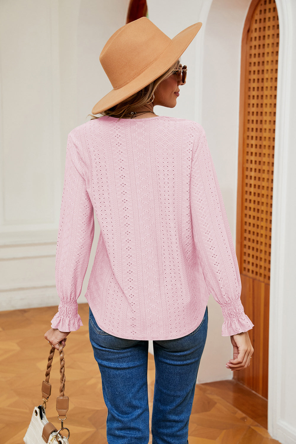 Detail shot: delicate sleeve seam and perfect opaque finish against a minimalist backdrop.

