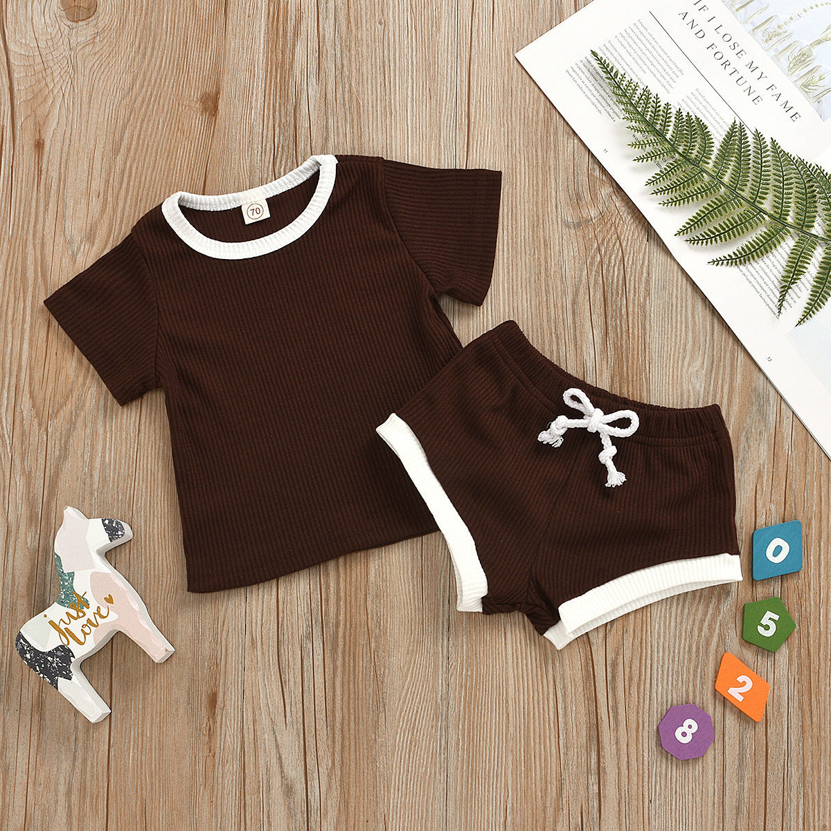 Detailed stitching on the all-trimmed infant two-piece set for toddlers.