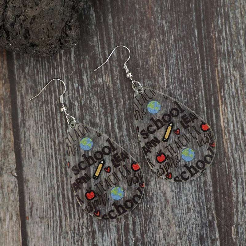 Hypoallergenic teardrop earrings resting on soft fabric

