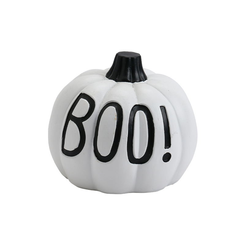 White decorative pumpkin with black BOO! lettering, a short dark stem and vertical molded grooves on a pure white background.