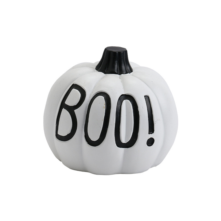 White decorative pumpkin with black BOO! lettering, a short dark stem and vertical molded grooves on a pure white background.