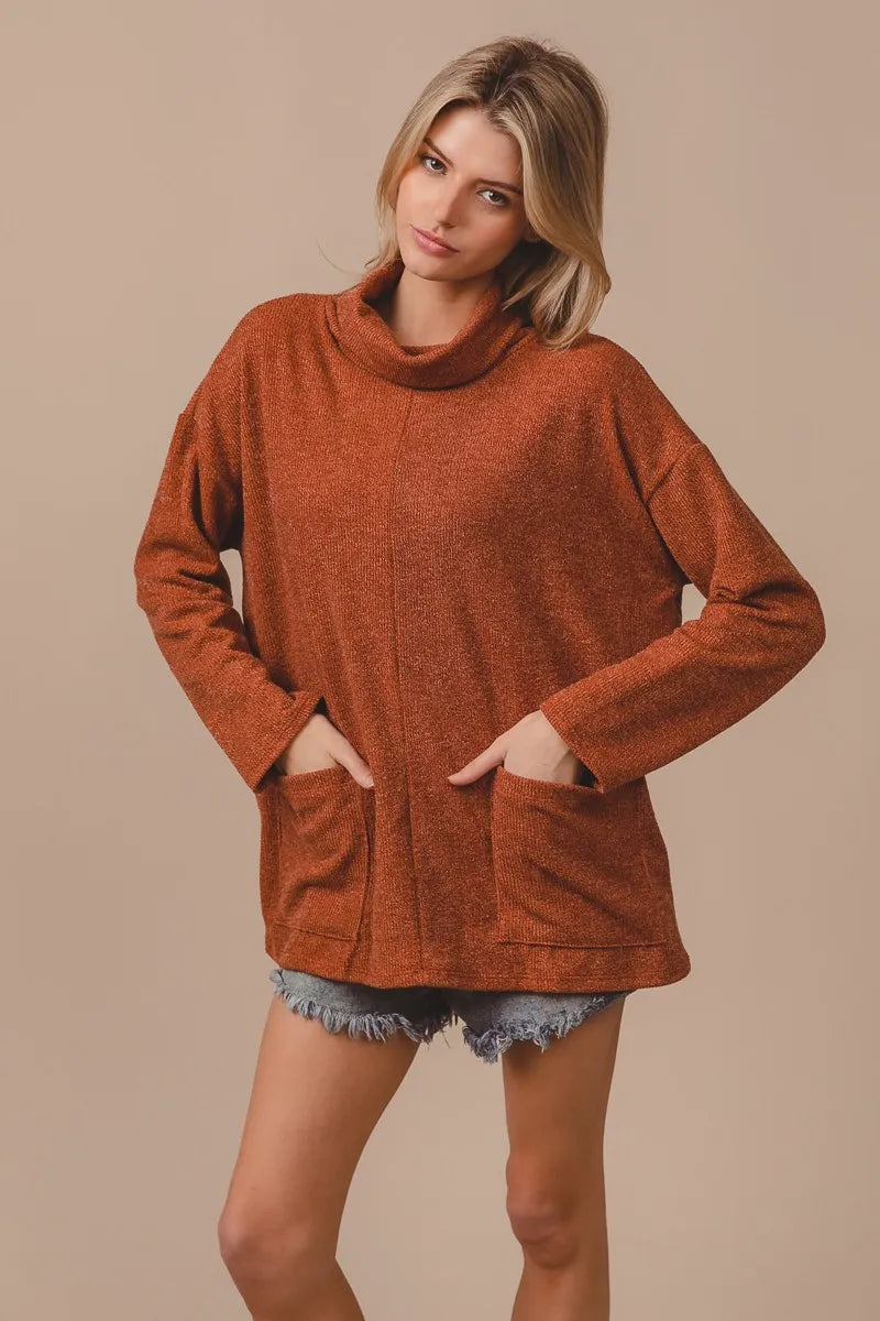 Fabric drape: show 80% rayon/20% nylon stretch and recovery on the Rib Double Pocket Turtle Neck Top

