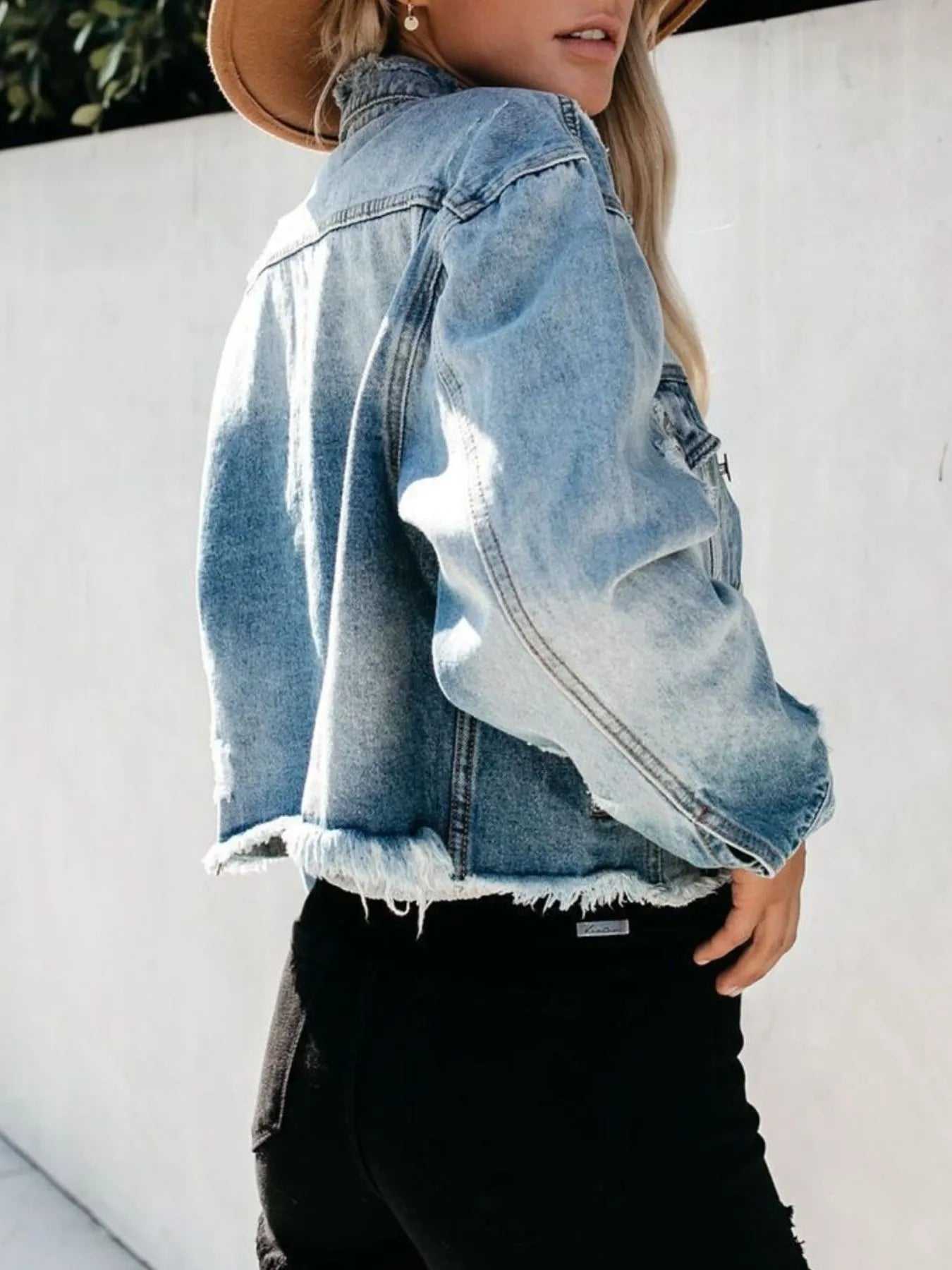 Female model wearing fashionable washed denim jacket

