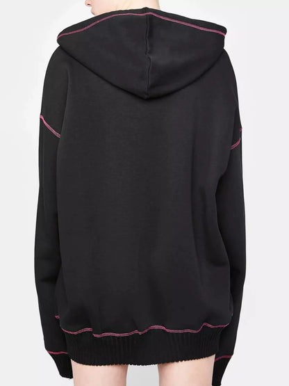 Festive setting with Women's Halloween Zip-Up Drawstring Hoodie, capturing zipper pull and drawstring ties to inspire immediate Halloween excitement.