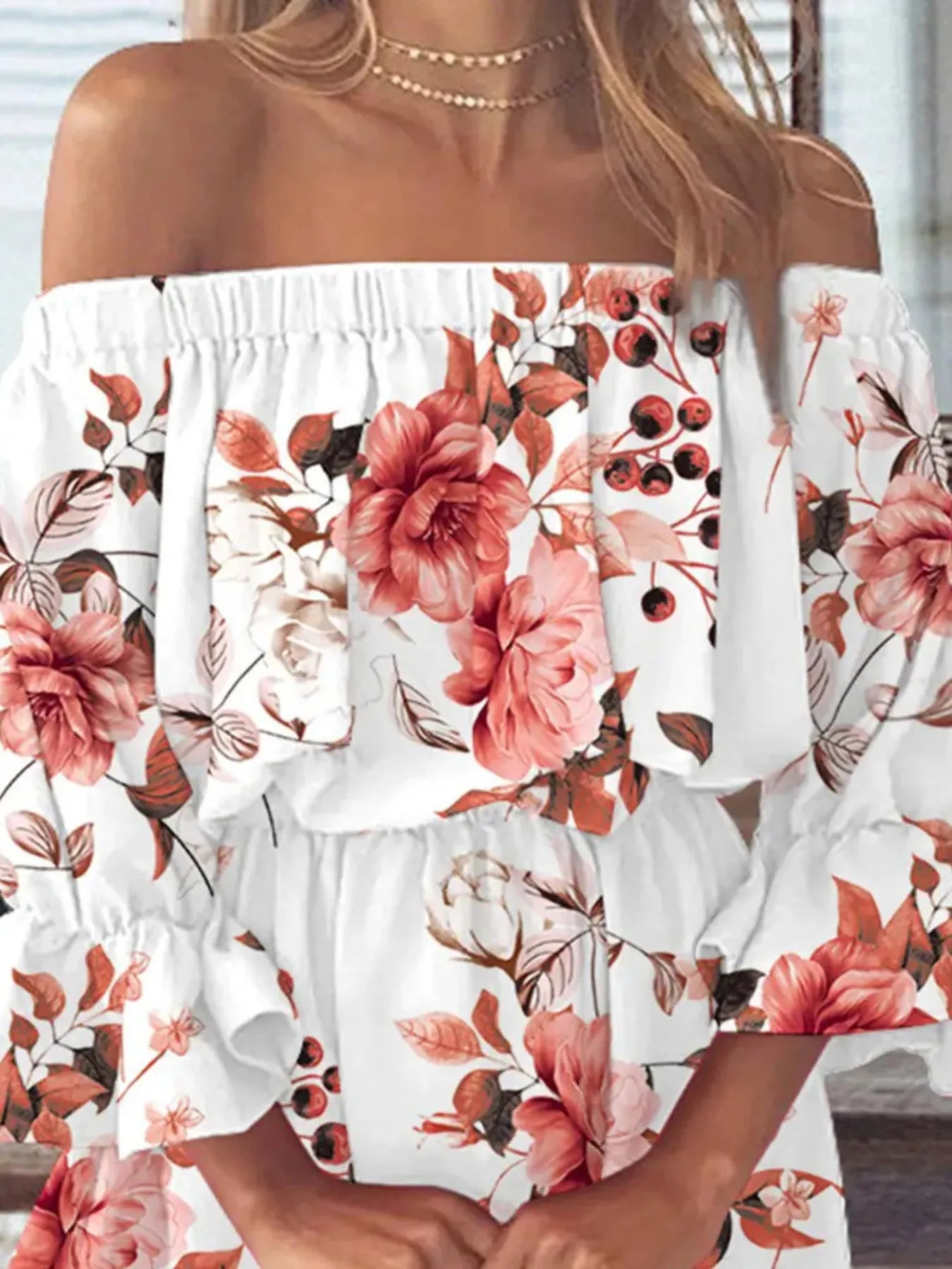 Flat lay of floral off-shoulder dress with matching accessories on white background

