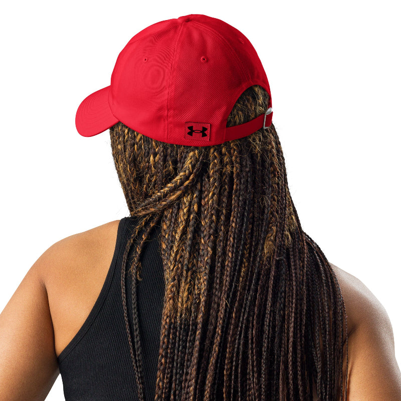 Front-facing view of couple wearing red and white Unisex Under Armour® Dad Hats with curved visors on a sunny day

