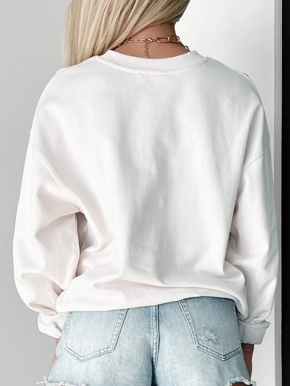 Girl laughing wearing LUCKY sweatshirt in natural light

