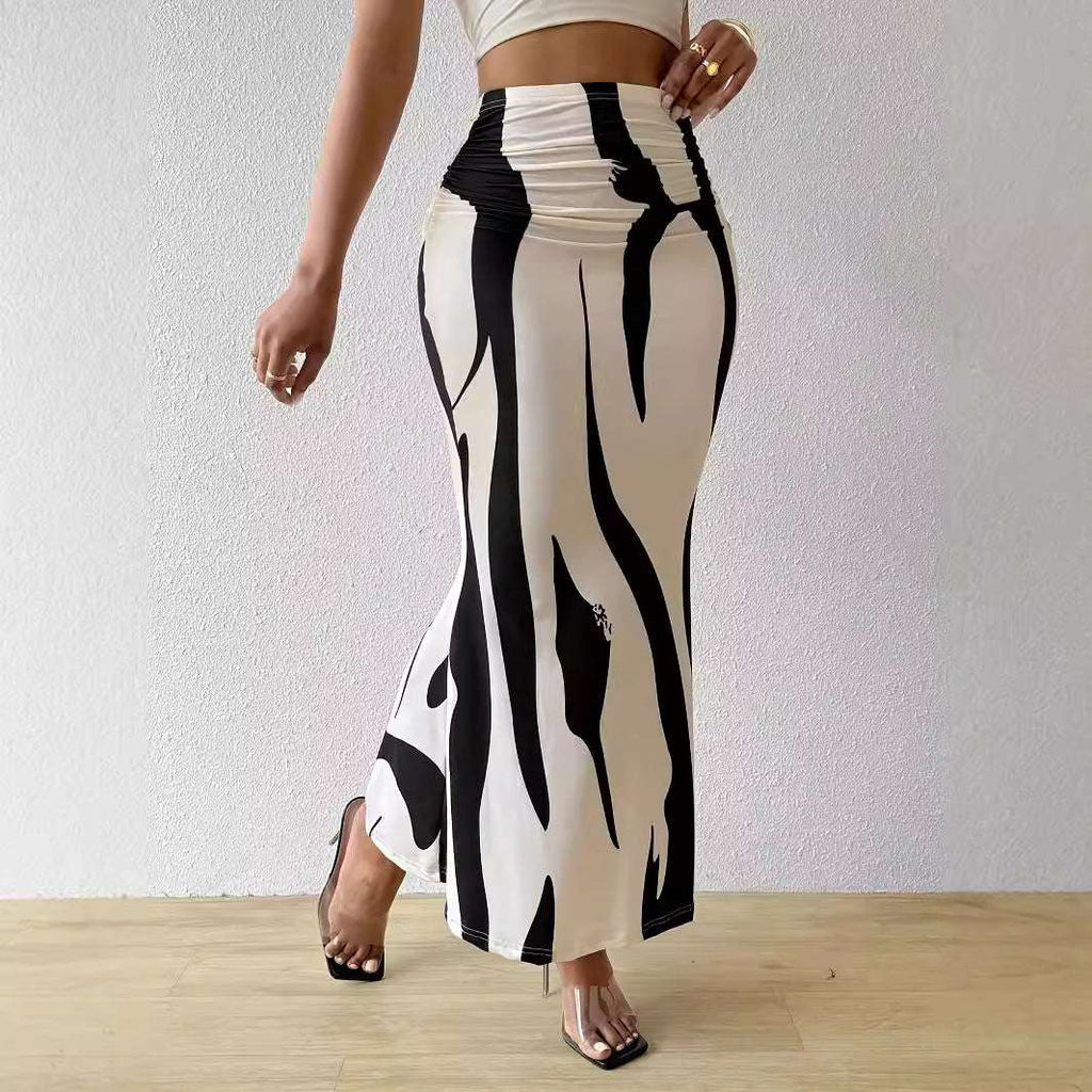 Blue zebra stripe dress paired with high heels and clutch bag

