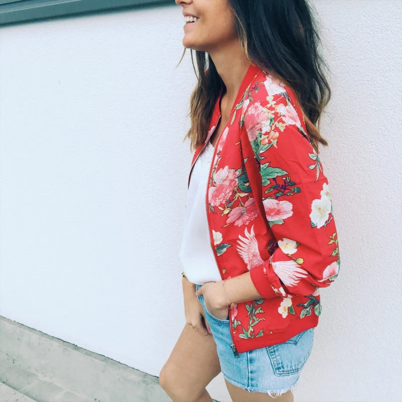 Side outfit view of the Red printed jacket with denim shorts, showing the open front, long sleeves and matching ribbed cuffs.