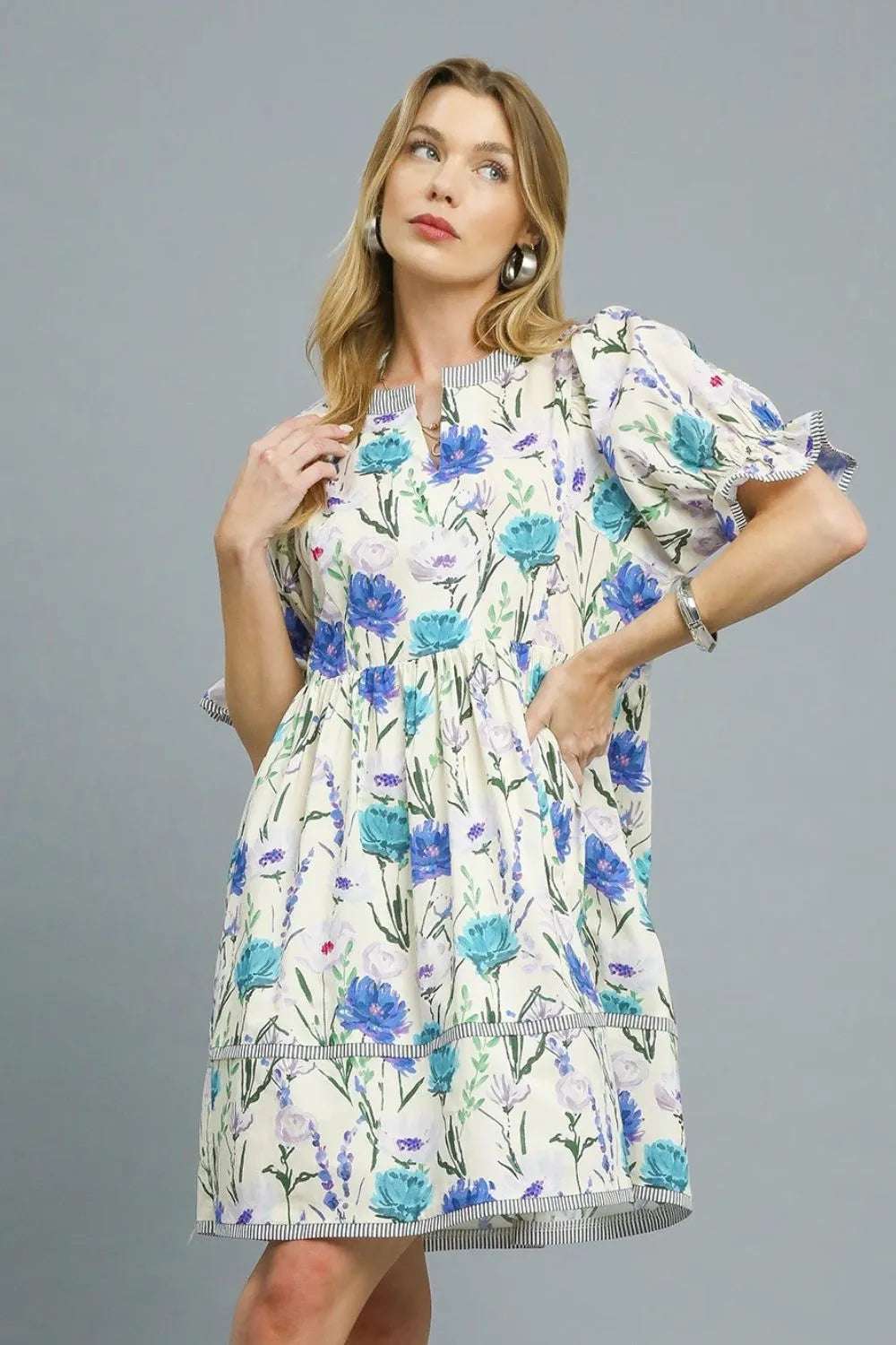 Model wearing Umgee BabyDoll Floral Striped Hem Mini Dress styled with sandals for casual summer look

