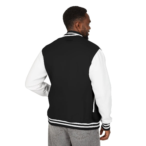 Model posing in KING letterman varsity jacket outdoors

