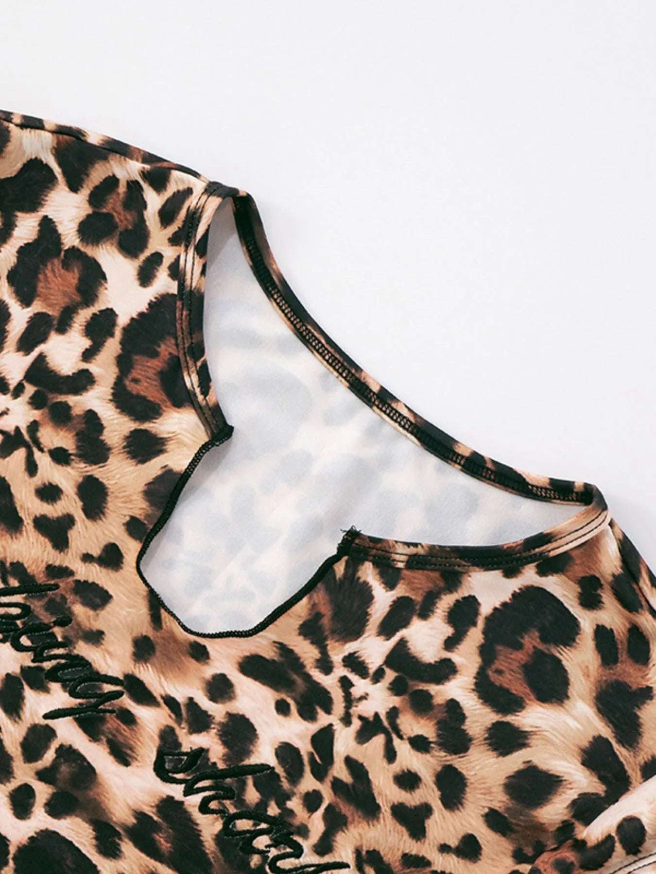 Model posing near window wearing leopard print women's set

