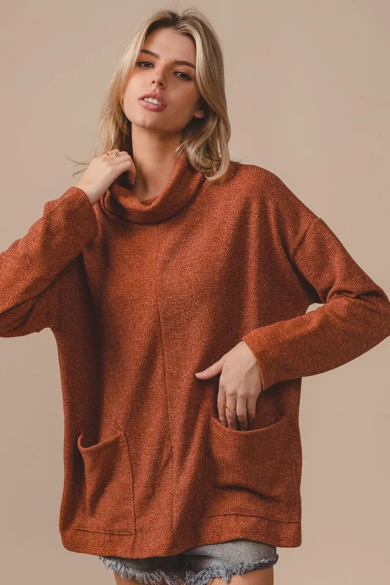 Lifestyle shot: pairing the Rib Double Pocket Turtle Neck Top with high-waist jeans

