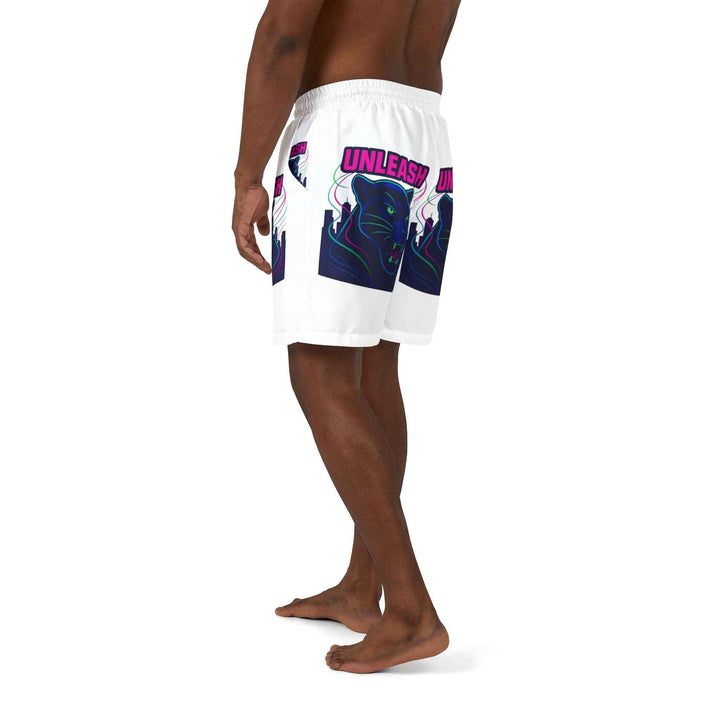 Model wearing panther print shorts while relaxing by water
