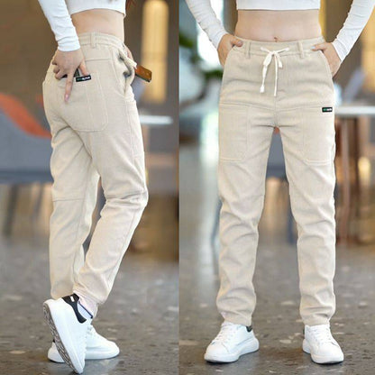 Model Striding in Beige Men's 6-Pocket Track Sweatpants – Effortless Loose Fit Captured