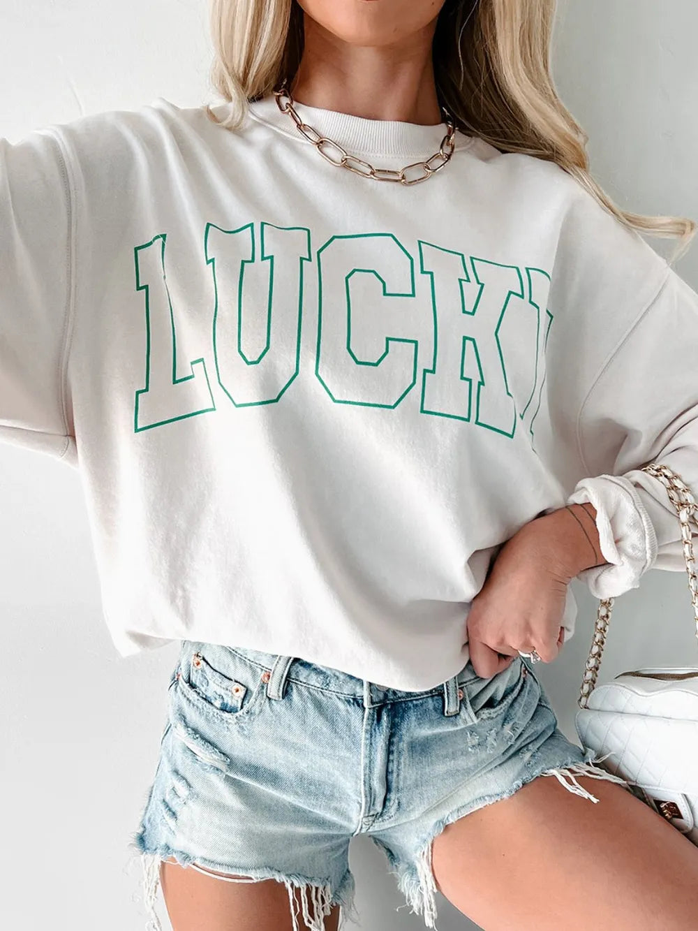 Model styling the sweatshirt with jeans and boots

