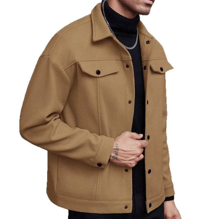 Earthy yellow jacket on a cropped model, showing a pointed collar, flap chest pockets and snap front on the white background.