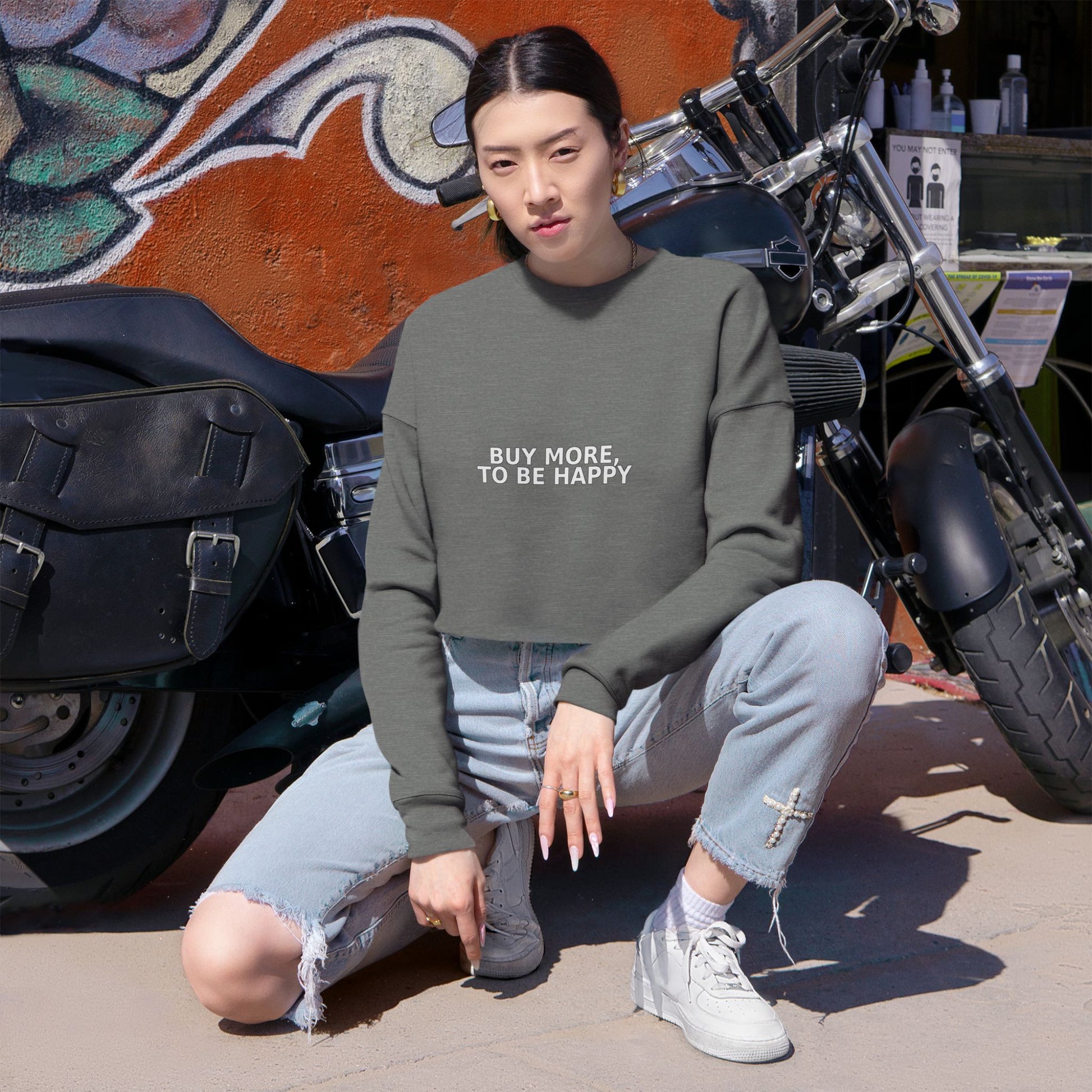 Olive green cropped sweatshirt showing a soft fabric side profile on a white backdrop.

