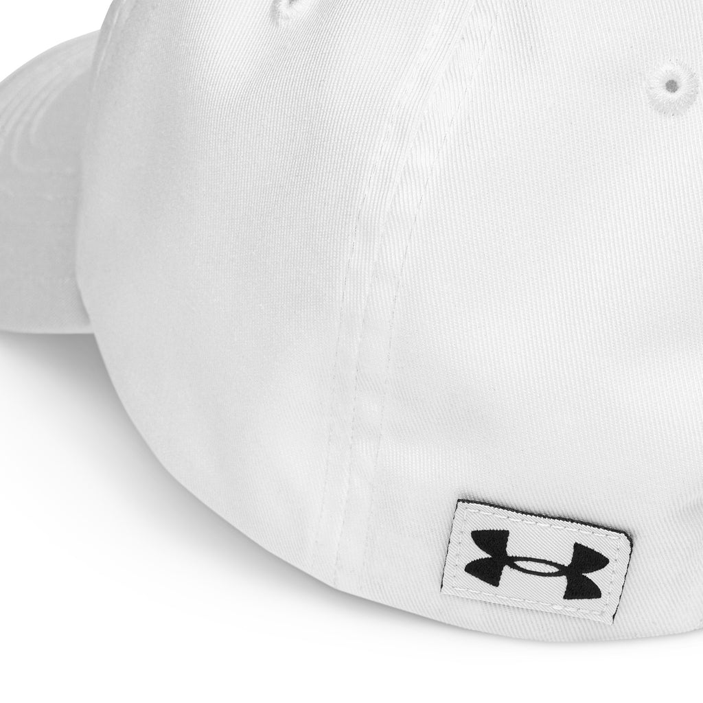 Outdoor lifestyle shot: red and white Unisex Under Armour® Dad Hat models standing on a tree-lined path

