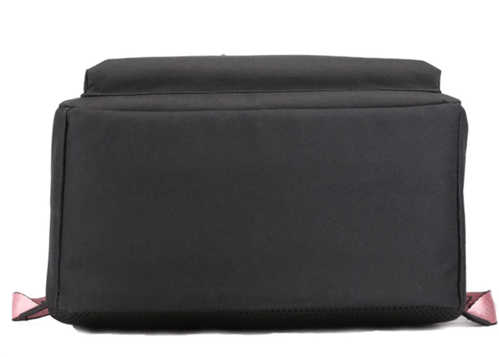 Bottom view of the plain black bag showing the flat rectangular base, black fabric, stitched seams and small pink strap ends.