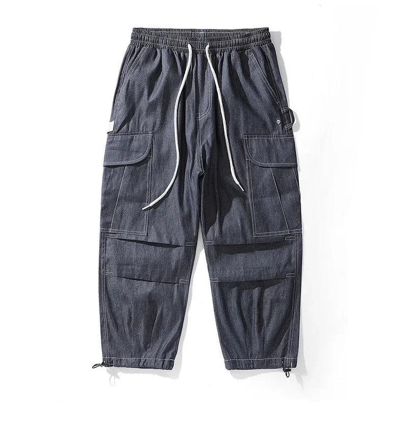 Original front view of navy blue cargo joggers with white drawstrings and flap pockets.