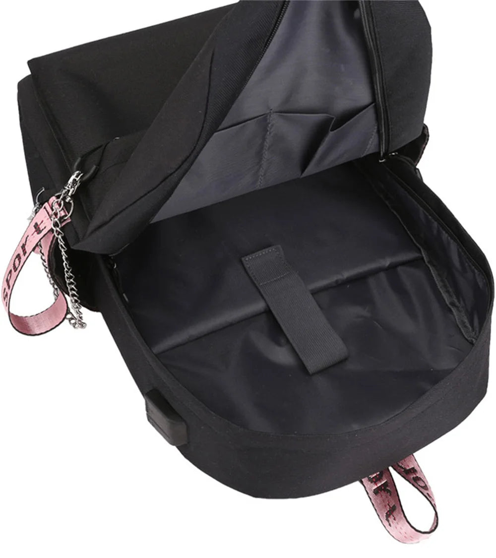 Inside the empty black reference backpack, showing nylon lining, a divided compartment and a retaining strap in a front view.