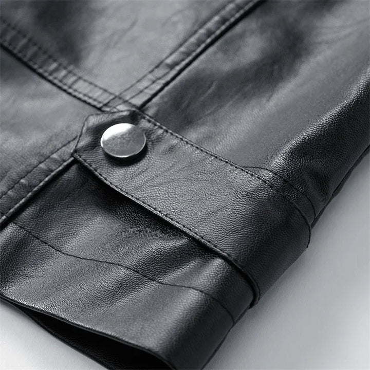 Close-up of black jacket snap fastener and seam