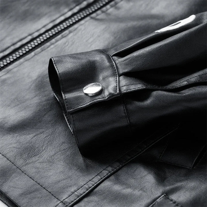 Close-up of black jacket cuff with snap