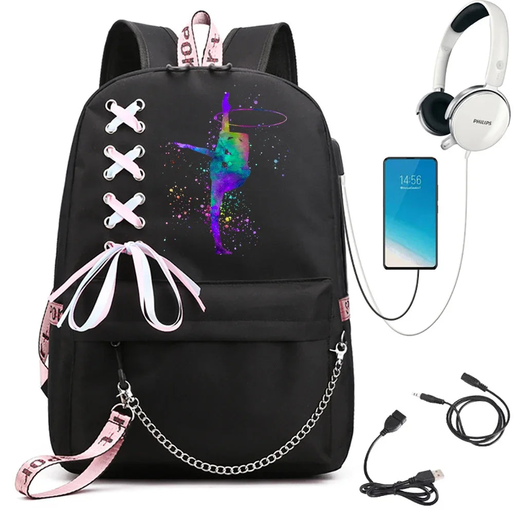 A black school backpack with a multicolor hoop gymnast print, ribbon lacing, pink trim and chain, beside demonstration props.