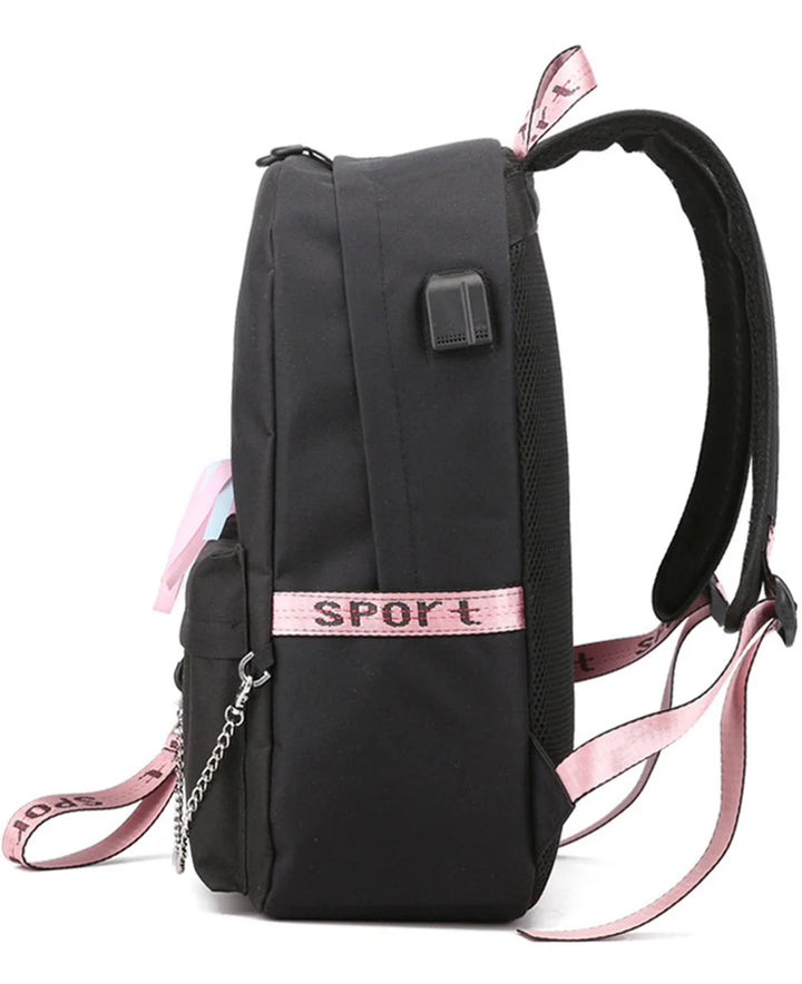 Side view of the black school backpack, showing its connection port, shoulder strap, pink webbing and silver chain in detail.