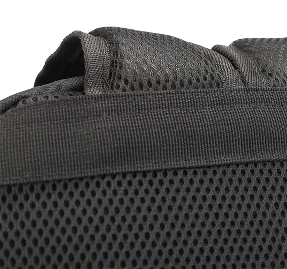 Close-up of a black shoulder strap and mesh panel on the reference backpack, showing fabric and stitched edges as shown here.