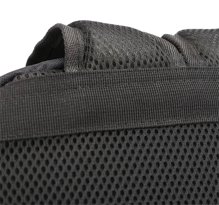 Close-up of a black shoulder strap and mesh panel on the reference backpack, showing fabric and stitched edges as shown here.