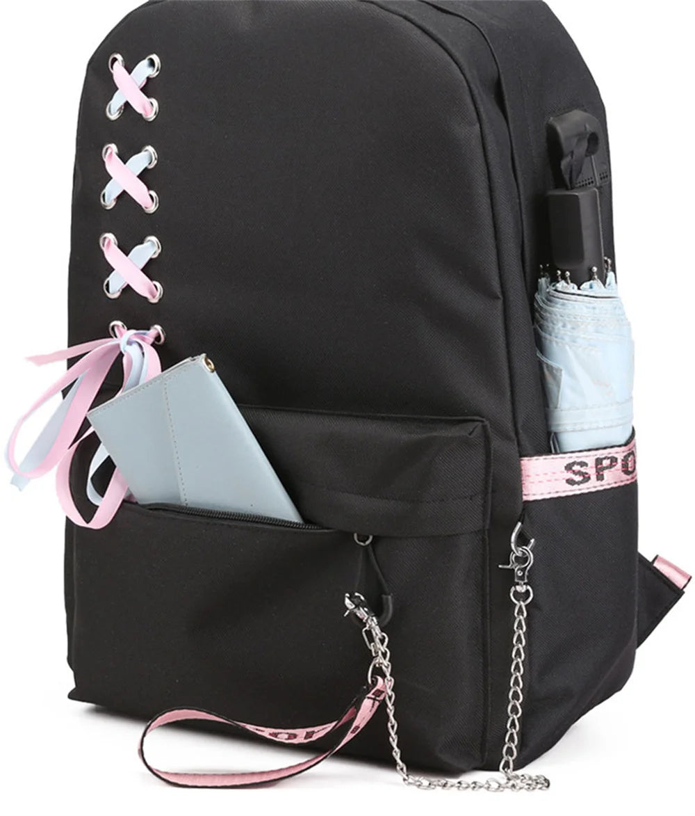 Plain black reference backpack featuring ribbon lacing and chain, showing a phone and umbrella as pocket examples in a photo.
