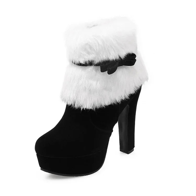 Single black boot on white background with a fluffy white cuff, matching bow strap, round toe, raised platform and high heel.