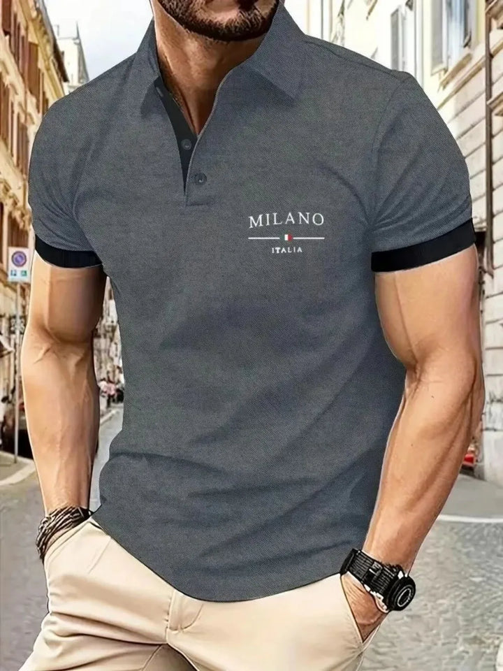 Man wearing a dark gray polo shirt with &