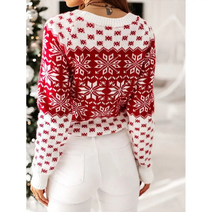 Back view of the red snowflake sweater with a white crew neck and white cuffs