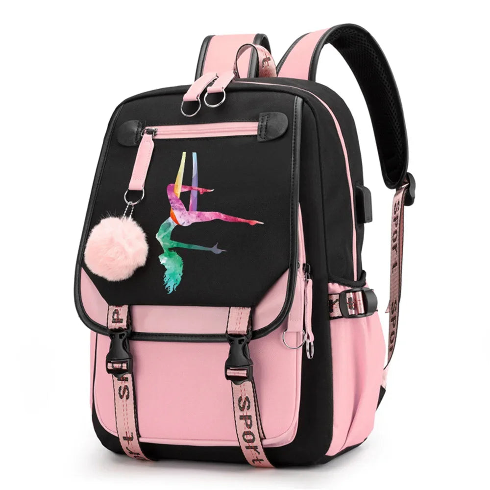 Pink and black backpack in design 1D-35-8 with a colorful gymnast print, buckle straps and pink pendant, shown against white.