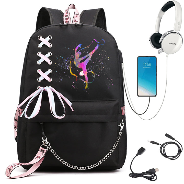 A black school backpack with pink and purple ribbon gymnast print, light pink ribbon bow and chain, beside electronics props.
