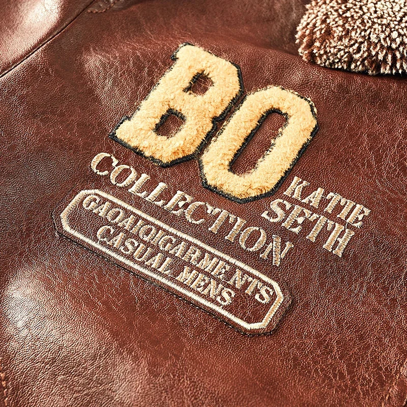 Brown jacket chest detail with the BO lettering, smaller stitched lettering and patch below.
