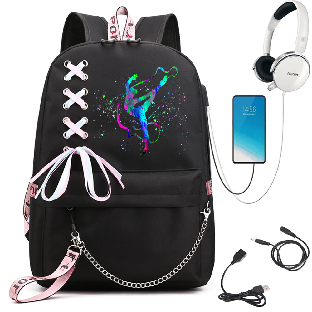 A black school backpack featuring blue and green gymnast artwork, pale ribbon bow and silver chain, beside electronics props.