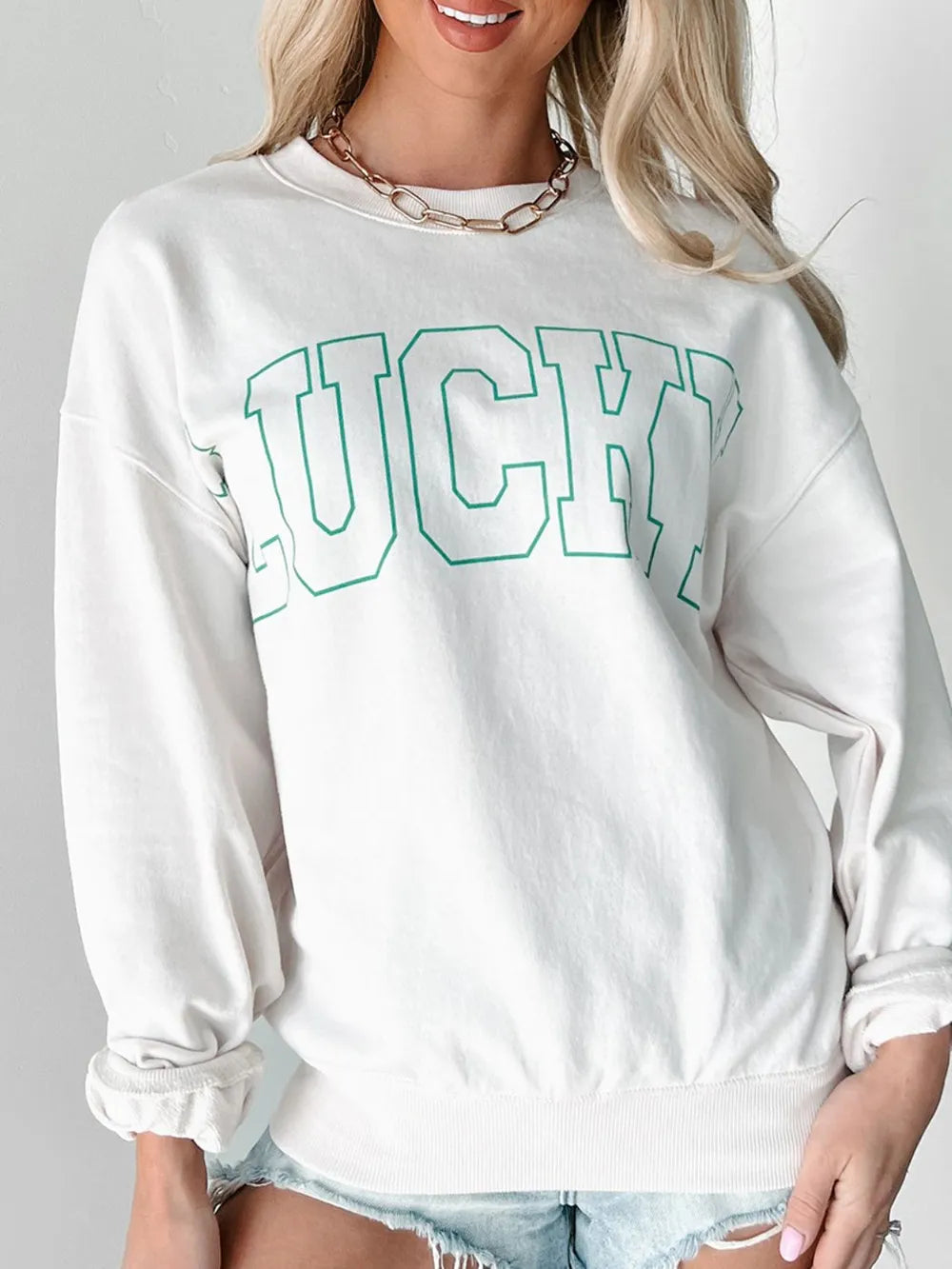 Side profile of woman in long sleeve sweatshirt and ponytail

