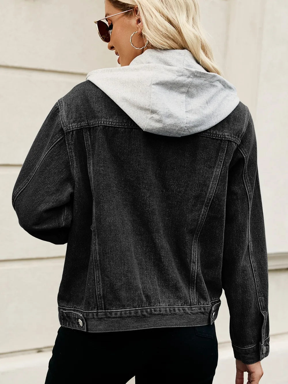 Stylish woman’s button-up denim jacket with oversized fit and street appeal.

