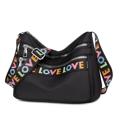 Timeless Black Oxford Cloth Crossbody Bag with Soft Fabric and Letter Embellishments