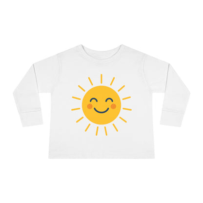 Unisex Sunny Smile Toddler Long Sleeve Tee styled with denim shorts for a fun family outing

